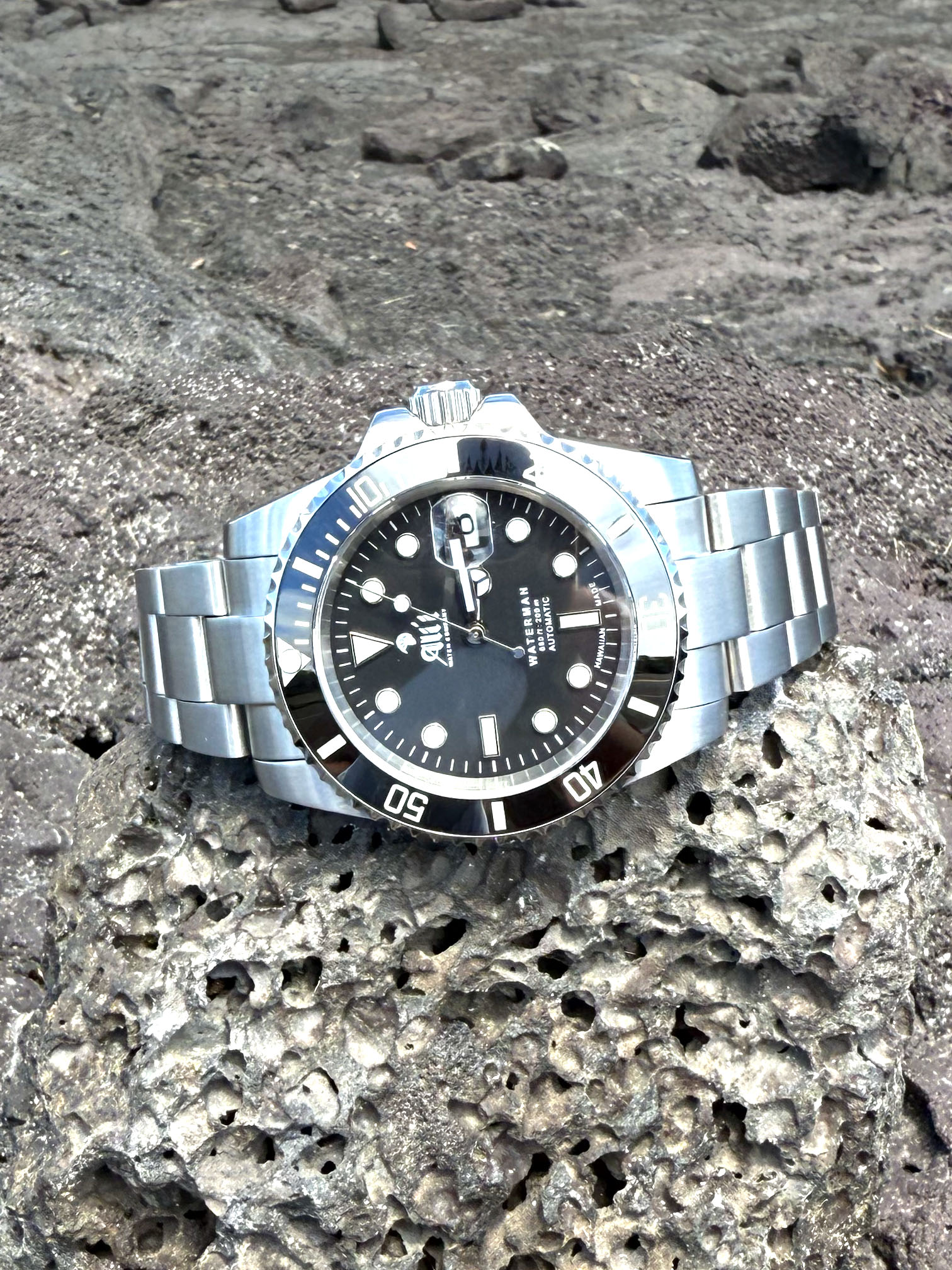 Waterman 41MM Black Dial Black Bezel Sports Watch sits on lava rock