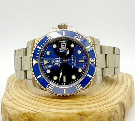 Ali'i Watch Company Waterman watch with a blue dial and bezel sits on a piece of wood.