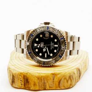 Ali'i Watch Company Waterman watch with a black bezel and carbon fiber bezel with blue minute markers sits on a piece of wood.