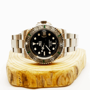Ali'i Watch Company Waterman watch with a black bezel and carbon fiber bezel with green minute markers sits on a piece of wood.