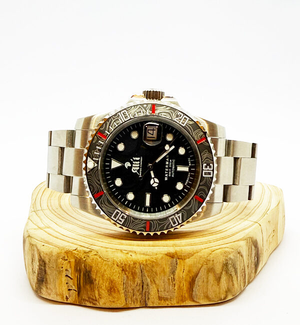 Ali'i Watch Company Waterman watch with a black bezel and carbon fiber bezel with red minute markers sits on a piece of wood.