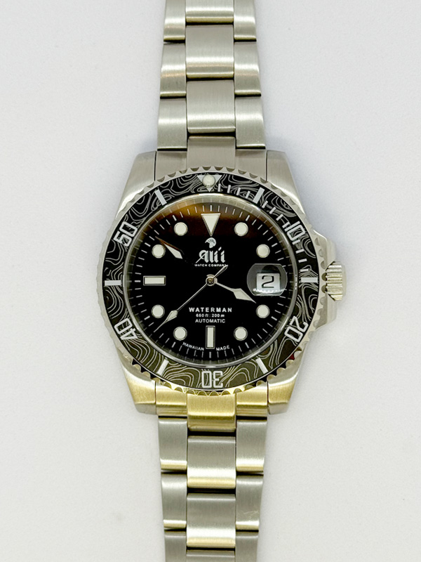 Front view of the Ali'i Watch Company Waterman watch with black dial and black carbon fiber bezel.