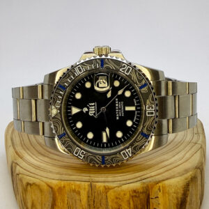 Ali'i Watch Company Waterman watch with a black bezel and carbon fiber bezel with blue minute markers sits on a piece of wood.