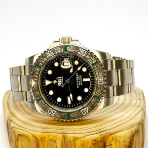 Ali'i Watch Company Waterman watch with a black bezel and carbon fiber bezel with green minute markers sits on a piece of wood.