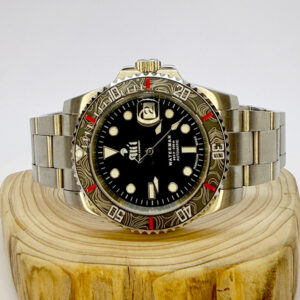 Ali'i Watch Company Waterman watch with a black bezel and carbon fiber bezel with red minute markers sits on a piece of wood.